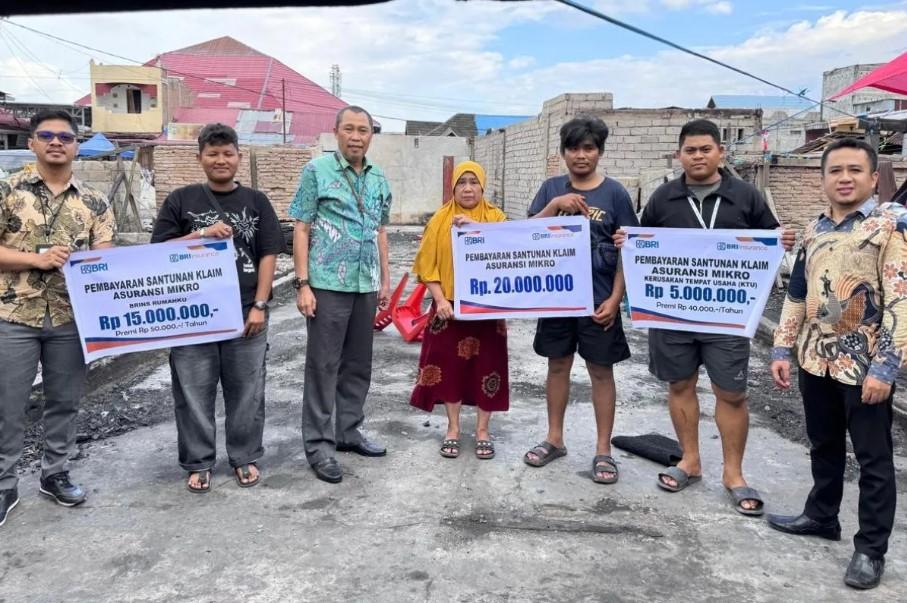 BRI Insurance Bayarkan Klaim Asuransi kepada Korban Kebakaran Pasar Masomba Palu